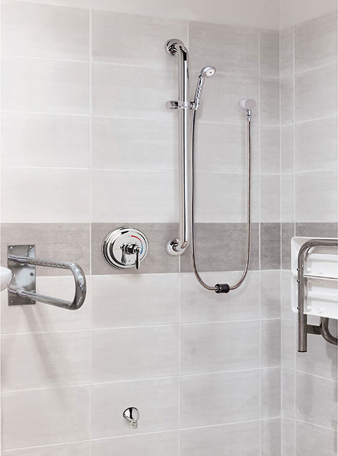 Chicago Faucets: AutoDrain Shower System installed in facility shower with handicap bars