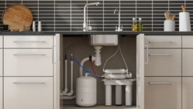 Front View Of Reverse Osmosis Water Filtration System In Kitchen Cabinet 