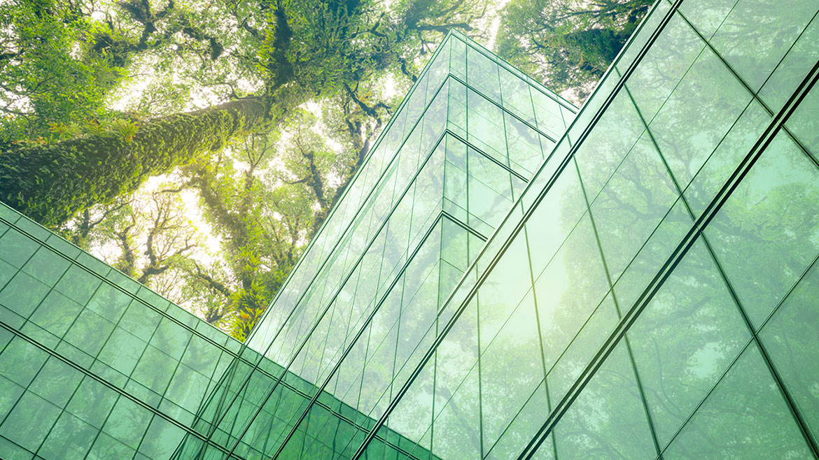 Sustainable glass office building with tree for reducing heat and carbon dioxide. Office building with green environment. Corporate building reduce CO2.